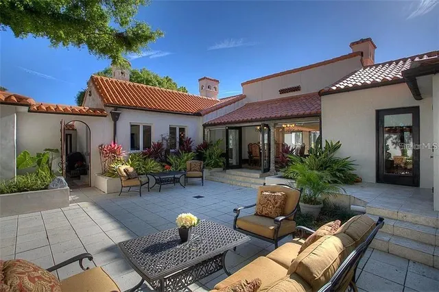 a view of a house with pool and sitting area