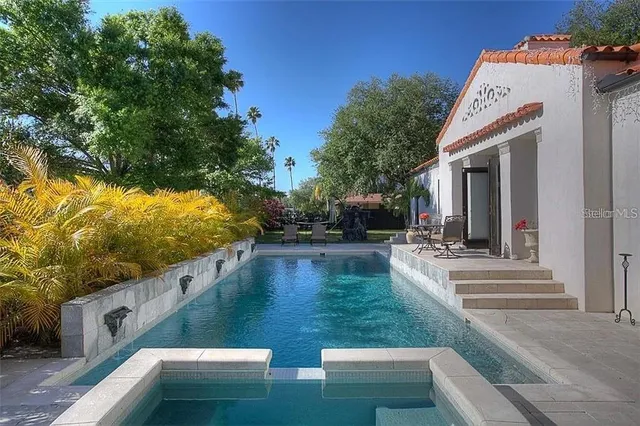 a view of a house with backyard sitting area and garden