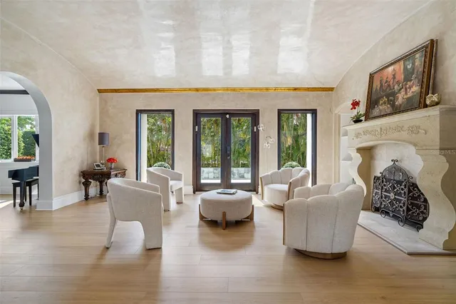 a living room with fireplace furniture and a wooden floor