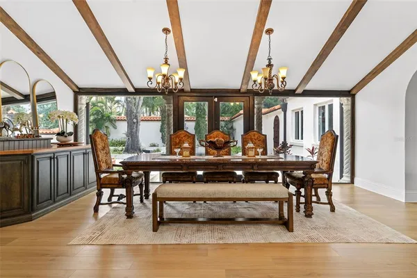 a living room with furniture a wooden floor and a chandelier