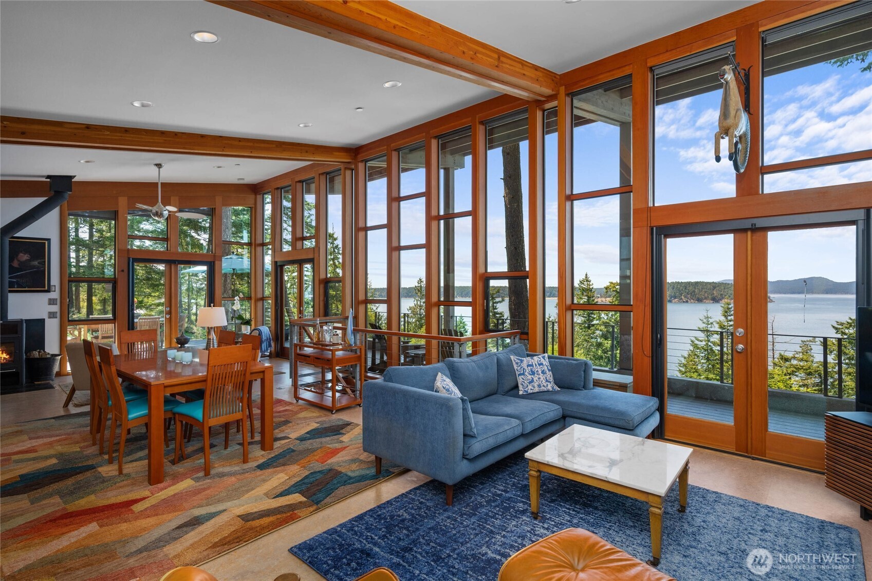405 Northwest Thatcher Pass Road Decatur Island, WA 98221 - Photo 4 of 40 a living room with furniture and a floor to ceiling window