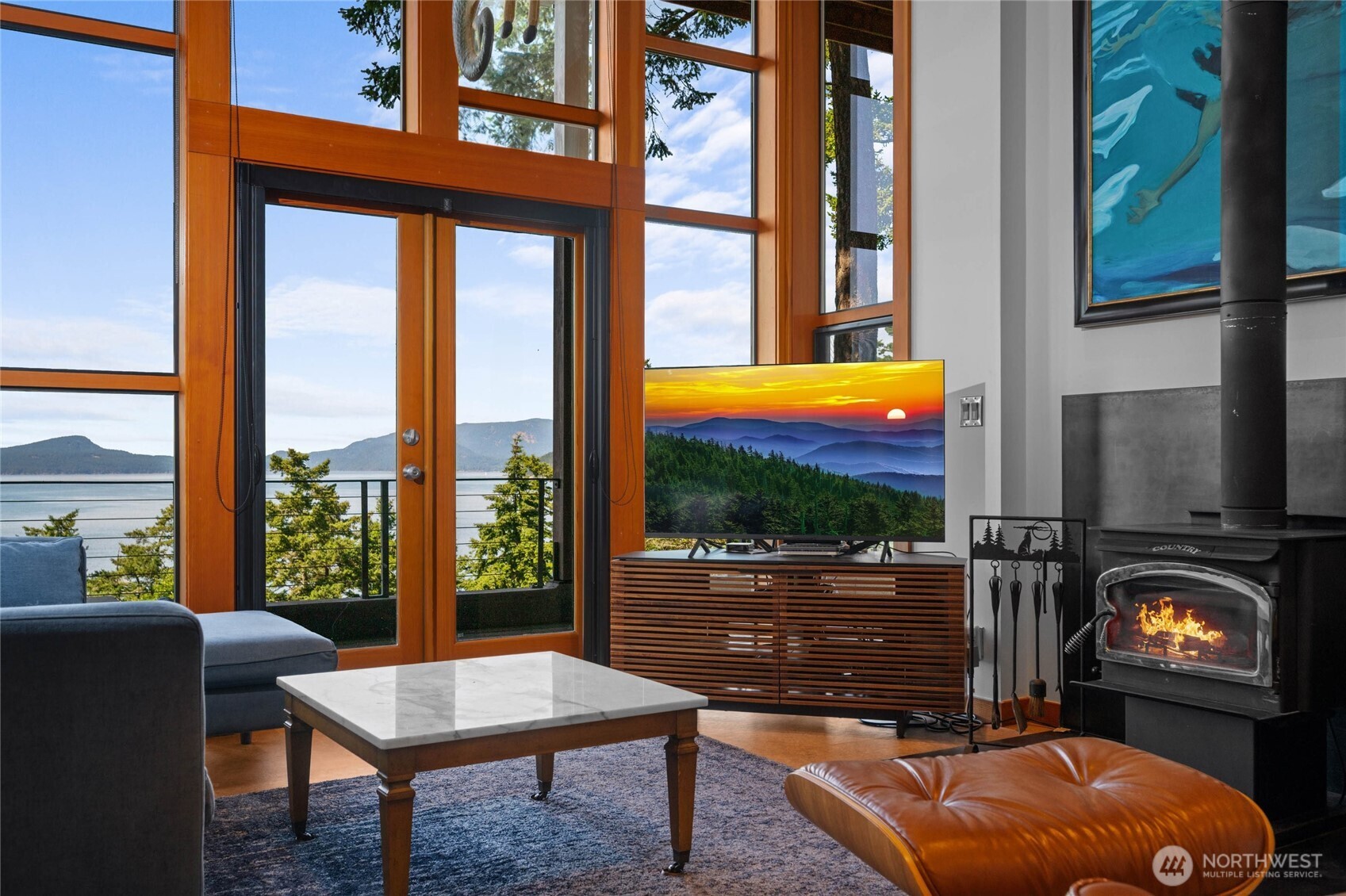 405 Northwest Thatcher Pass Road Decatur Island, WA 98221 - Photo 5 of 40 a living room with table chairs and a flat screen tv
