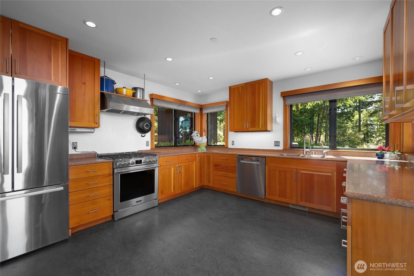 405 Northwest Thatcher Pass Road Decatur Island, WA 98221 - Photo 8 of 40 a kitchen with stainless steel appliances granite countertop a stove a sink dishwasher and a refrigerator