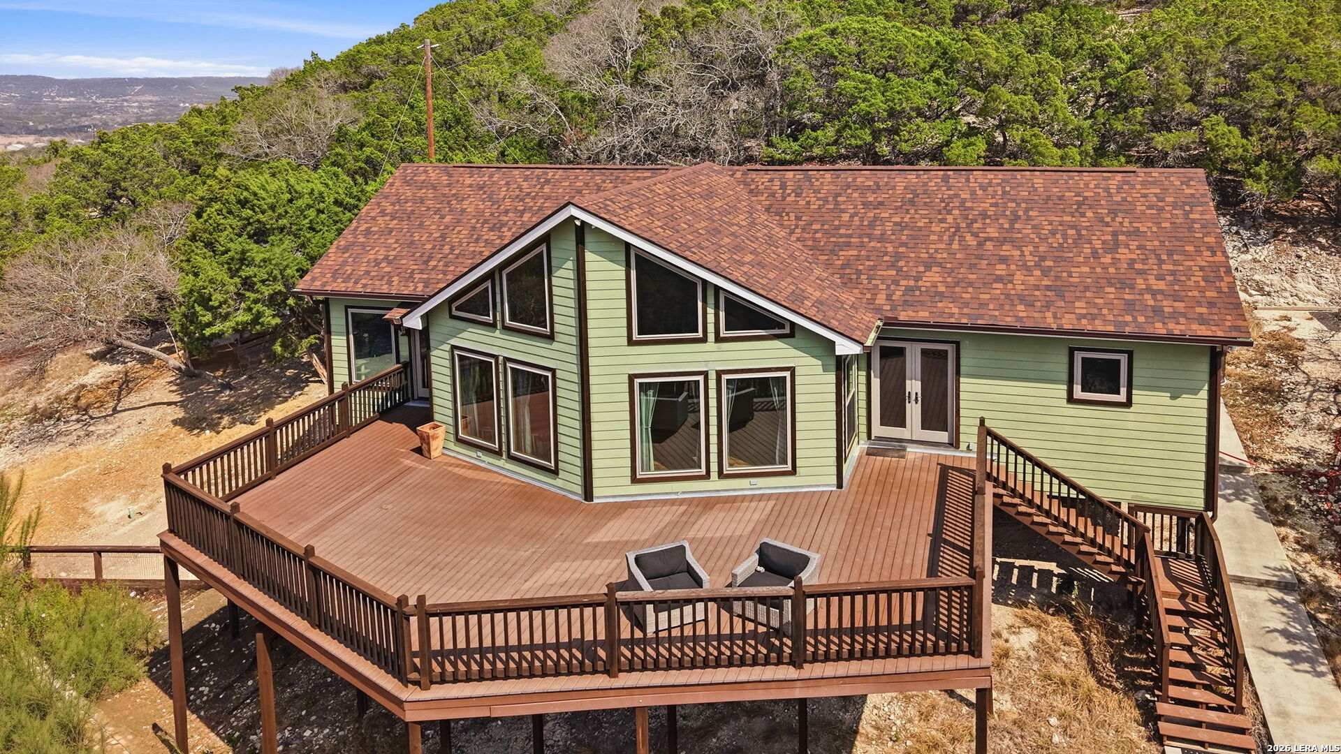 232 Doe Run Road Pipe Creek, TX 78063 - Photo 1 of 40 a view of a house with a roof deck