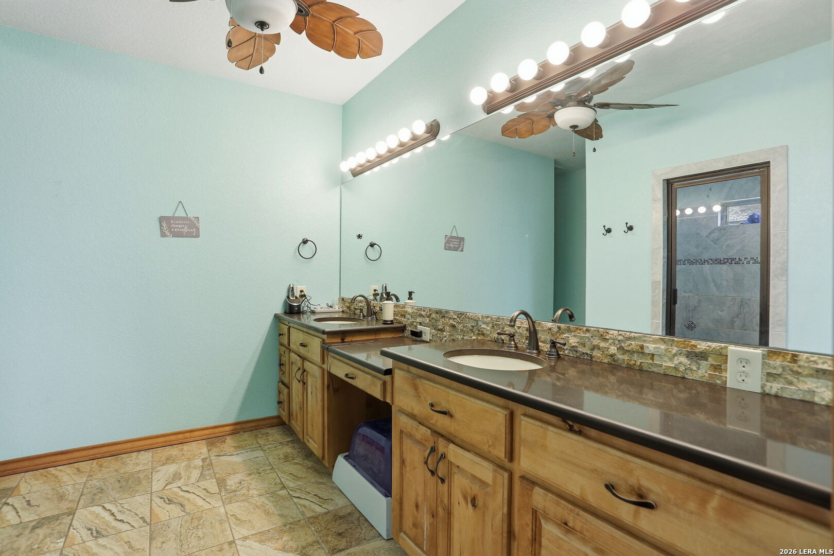 232 Doe Run Road Pipe Creek, TX 78063 - Photo 15 of 40 a bathroom with a sink and a mirror