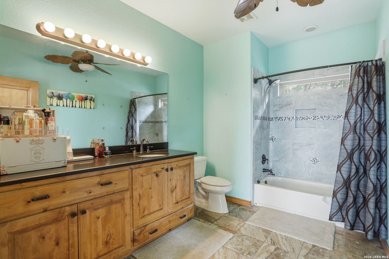 232 Doe Run Road Pipe Creek, TX 78063 - Photo 20 of 40 a spacious bathroom with a double vanity sink a toilet a mirror and shower