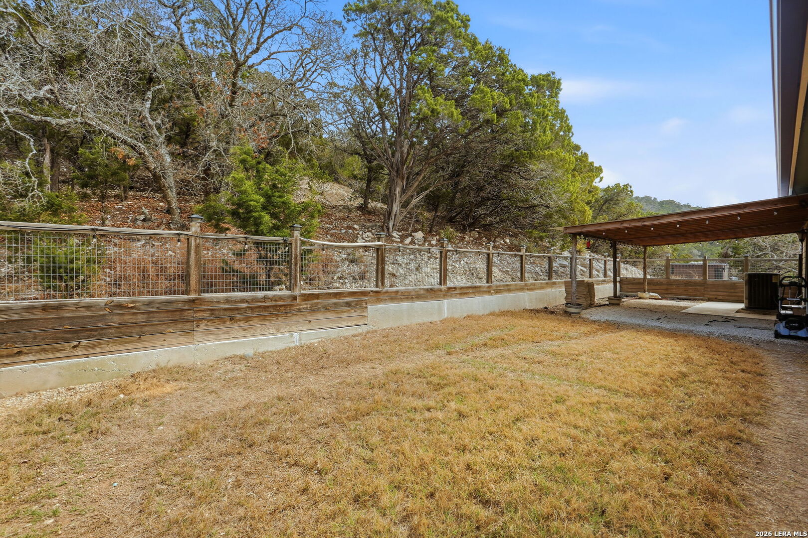 232 Doe Run Road Pipe Creek, TX 78063 - Photo 26 of 40 a swimming pool with outdoor seating and yard