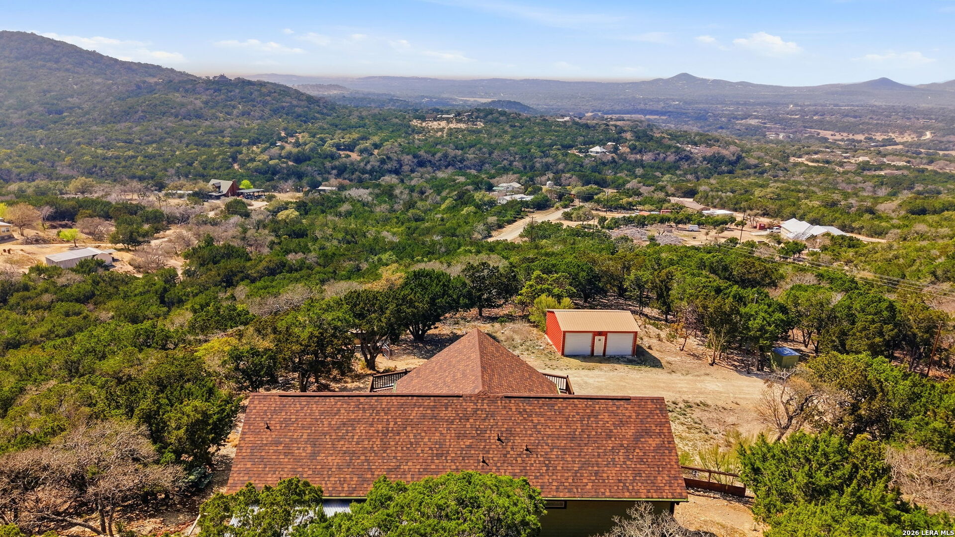 232 Doe Run Road Pipe Creek, TX 78063 - Photo 34 of 40 an aerial view of a house with a mountain in the background