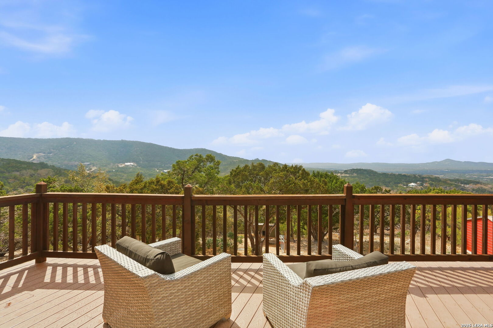 232 Doe Run Road Pipe Creek, TX 78063 - Photo 4 of 40 a view of a chairs on a deck