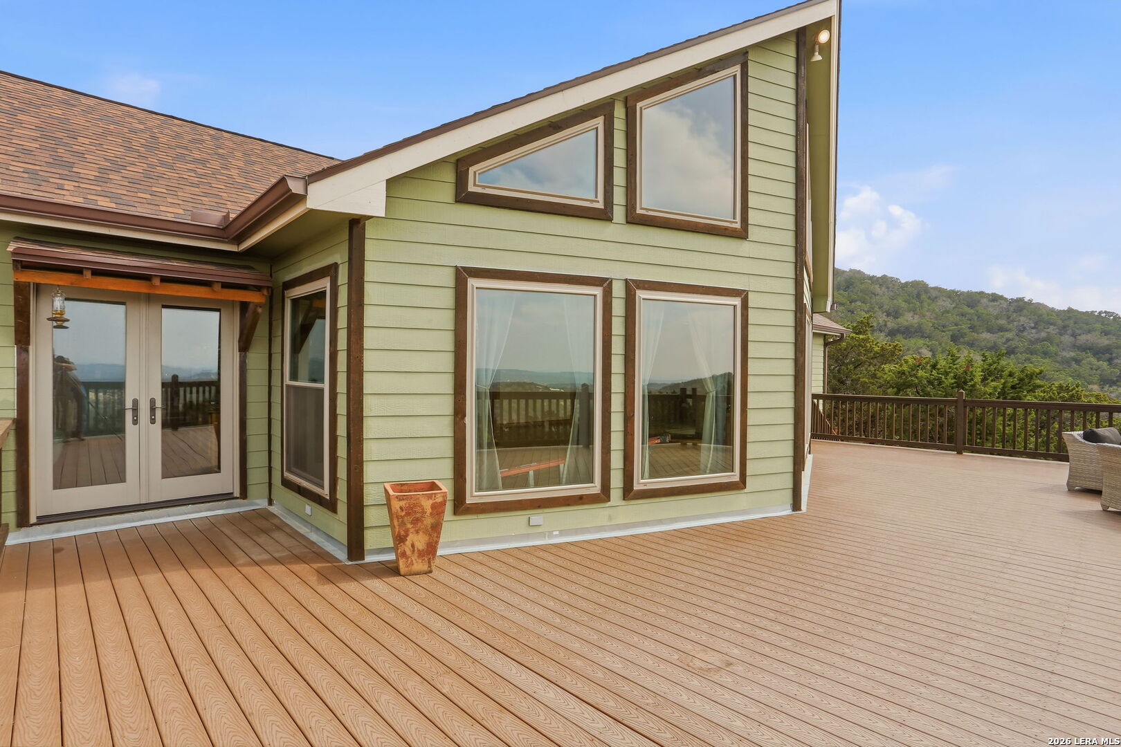 232 Doe Run Road Pipe Creek, TX 78063 - Photo 5 of 40 a view of a house with a wooden deck