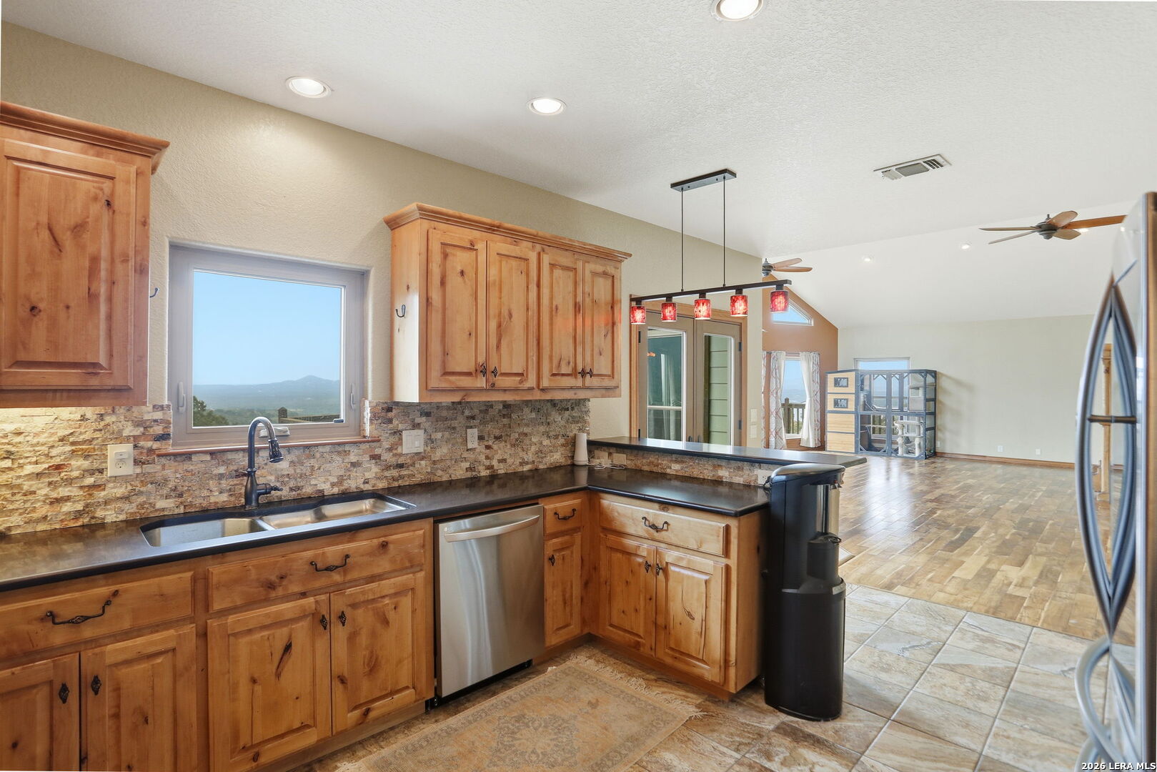 232 Doe Run Road Pipe Creek, TX 78063 - Photo 10 of 40 a kitchen with a sink stove and cabinets