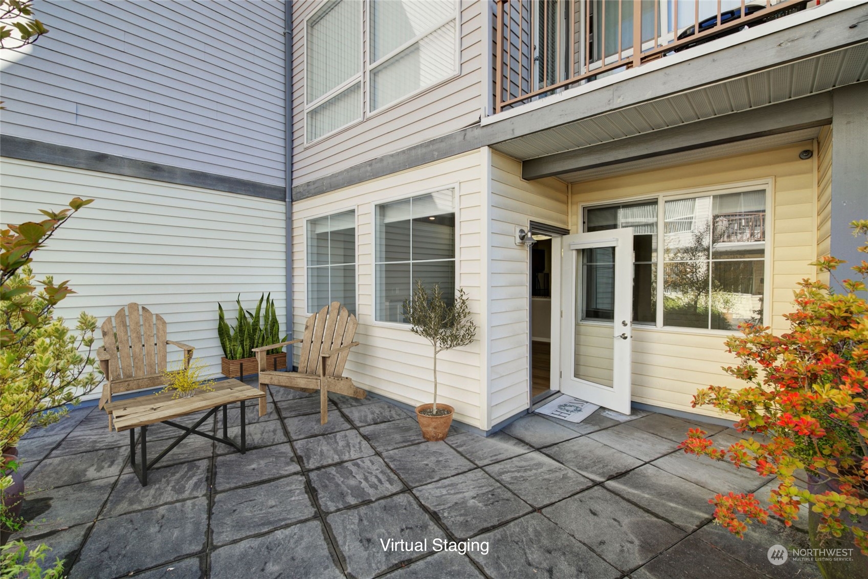 225 Logan Avenue South, Unit 108 Renton, WA 98057 - Photo 12 of 23 a white house with potted plants in front of door