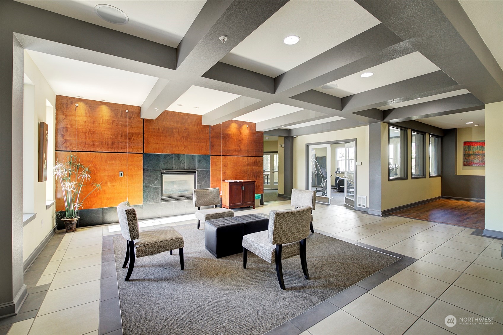 225 Logan Avenue South, Unit 108 Renton, WA 98057 - Photo 19 of 23 a living room with furniture a fireplace and a large window