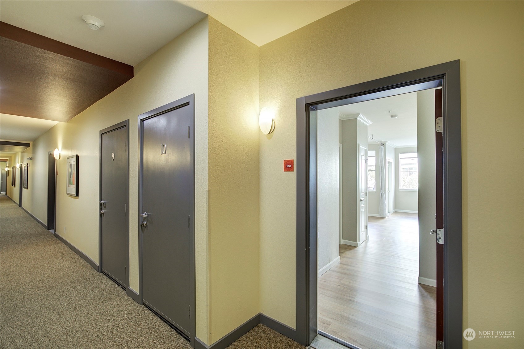 225 Logan Avenue South, Unit 108 Renton, WA 98057 - Photo 22 of 23 a view of a hallway with wooden floor