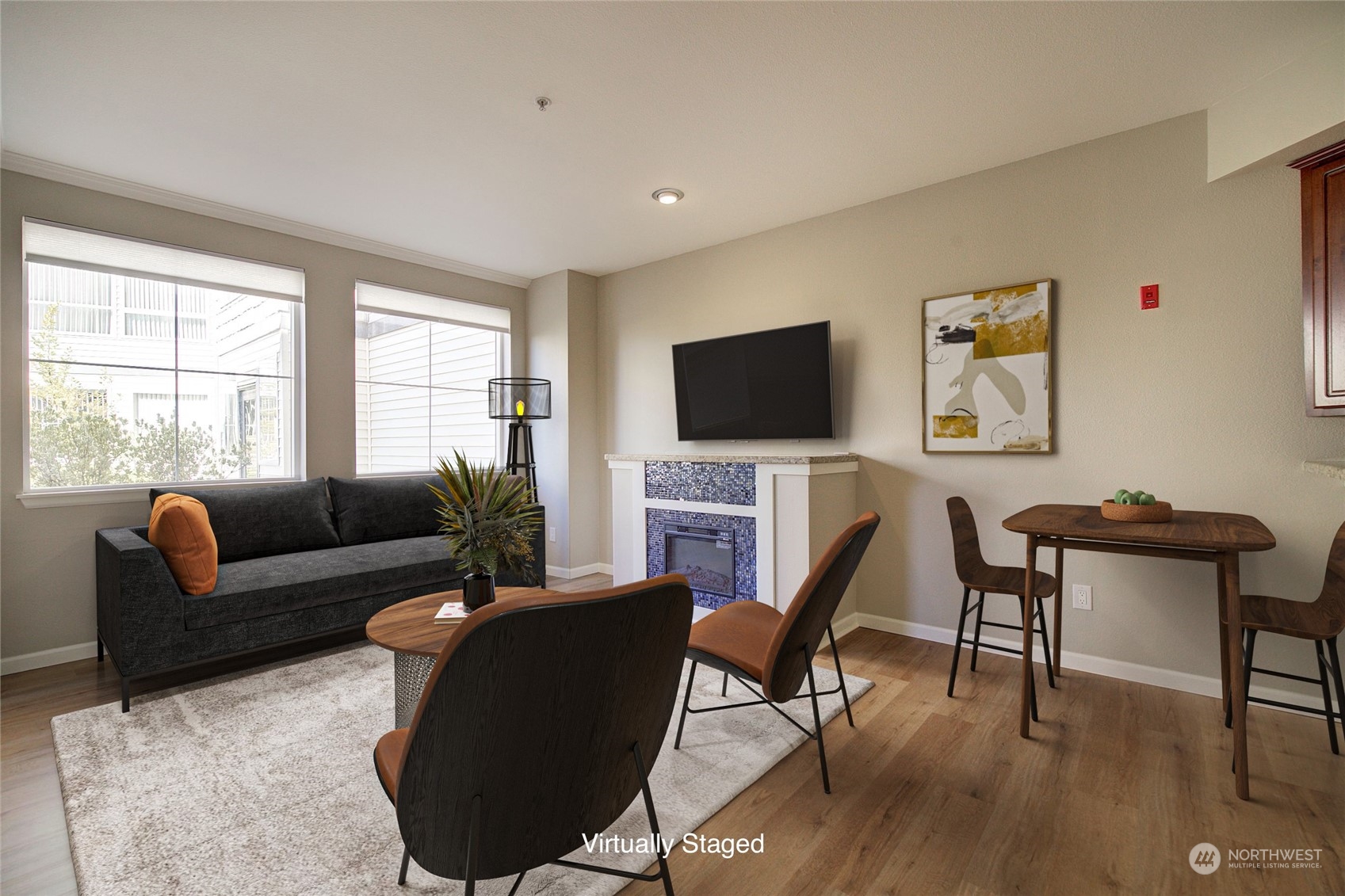 225 Logan Avenue South, Unit 108 Renton, WA 98057 - Photo 5 of 23 a living room with furniture a flat screen tv and a large window