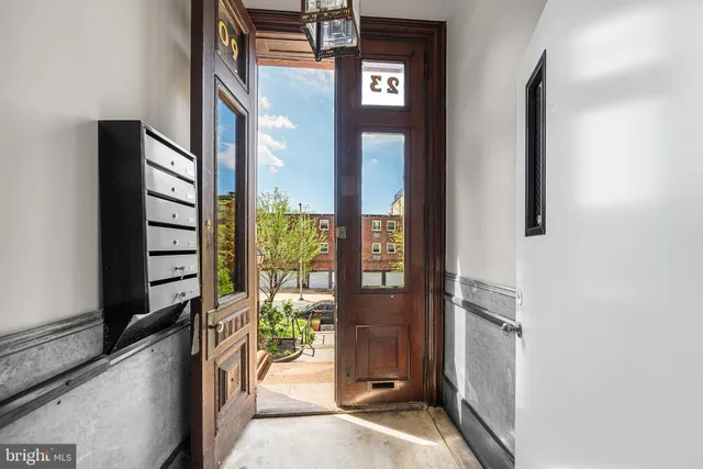 a view of a hallway with wooden floor and windows