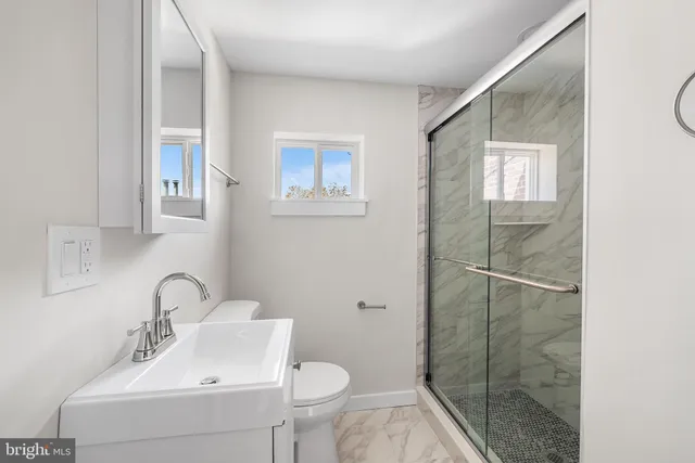 a bathroom with a sink toilet and shower