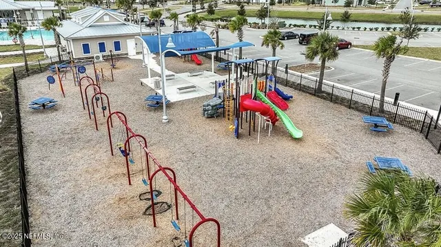 a view of a patio with a table and chairs under an umbrella