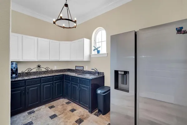 a kitchen with a sink cabinets and window