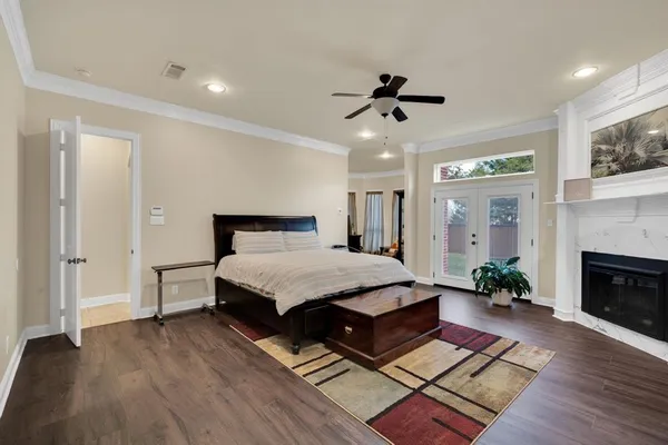 a spacious bedroom with a bed and a fireplace