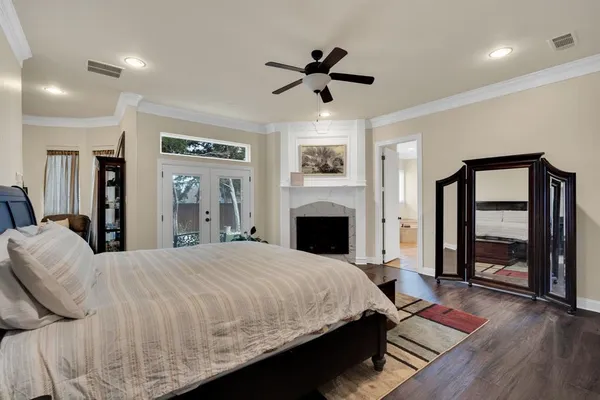 a bedroom with a large bed and a chandelier