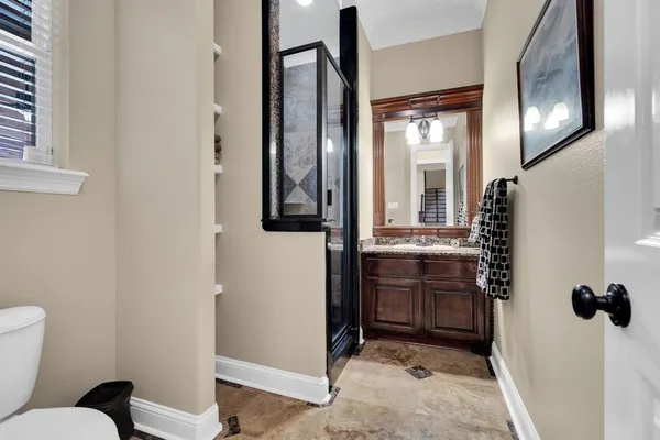 a bathroom with a toilet sink and mirror
