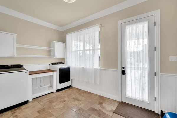 a kitchen with white cabinets and white appliances