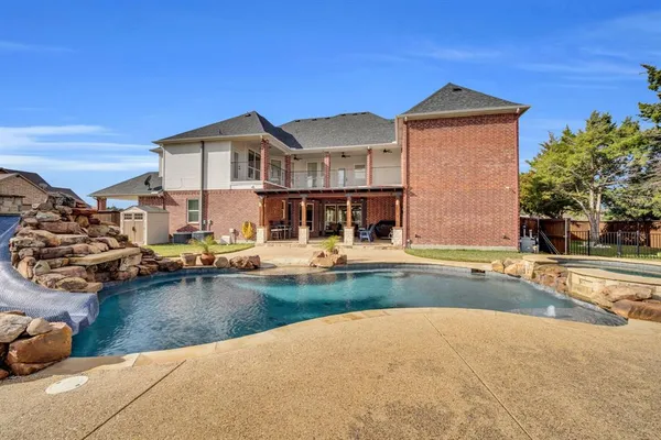 a view of a house with swimming pool and sitting area