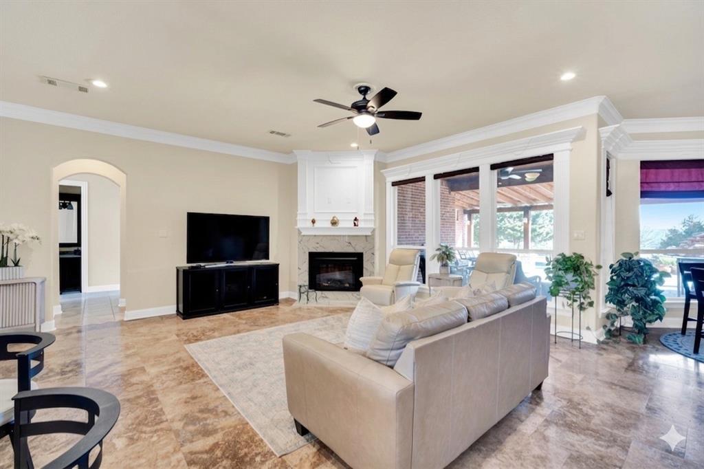 3530 Pleasantville Road Midlothian, TX 76065 - Photo 9 of 40 a living room with furniture a fireplace and a flat screen tv