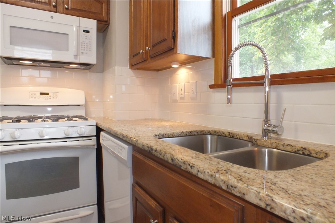 22651 Seabrooke Avenue Euclid, OH 44123 - Photo 14 of 31 Remodeled kitchen with new counter and sink, new garbage disposal, new dishwasher and new microwave, complete with delightful garden view!