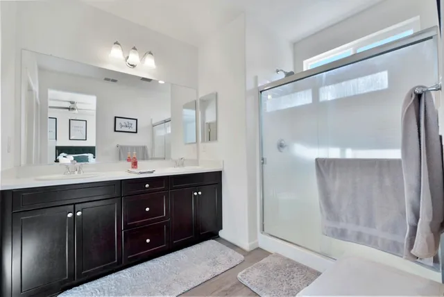 a view of a house with a yard and potted plants