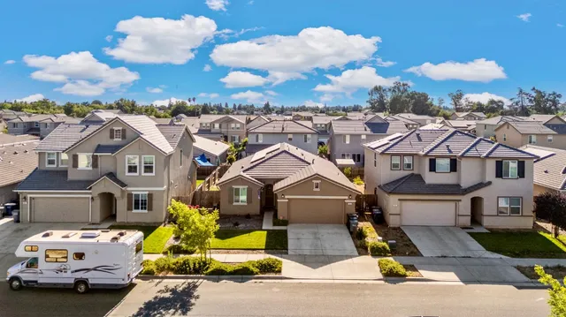 a aerial view of multi story residential apartment building with yard