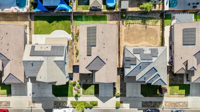 an aerial view of a residential houses with outdoor space