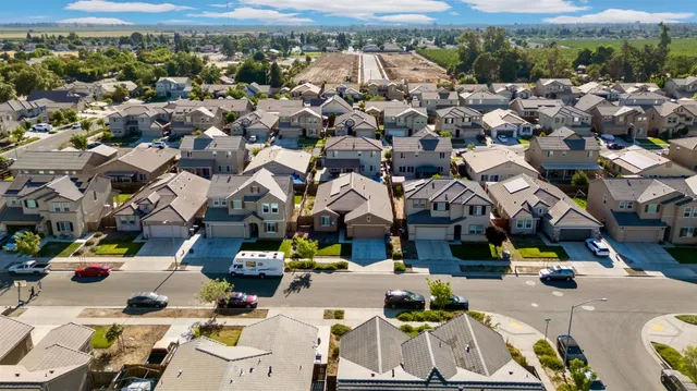 an aerial view of a houses with a city street