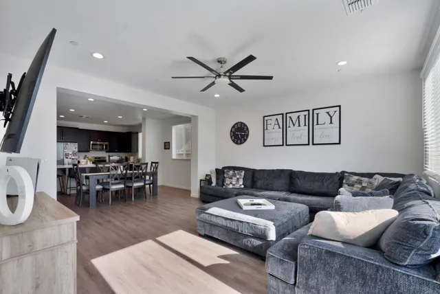 a living room with furniture and view of kitchen