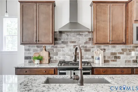 a kitchen with stainless steel appliances granite countertop a sink and cabinets