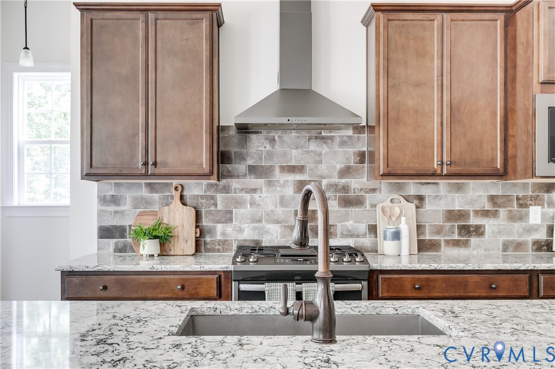 2512 Channelmark Court Chester, VA 23836 - Photo 13 of 36 Kitchen with range hood and gas stove.