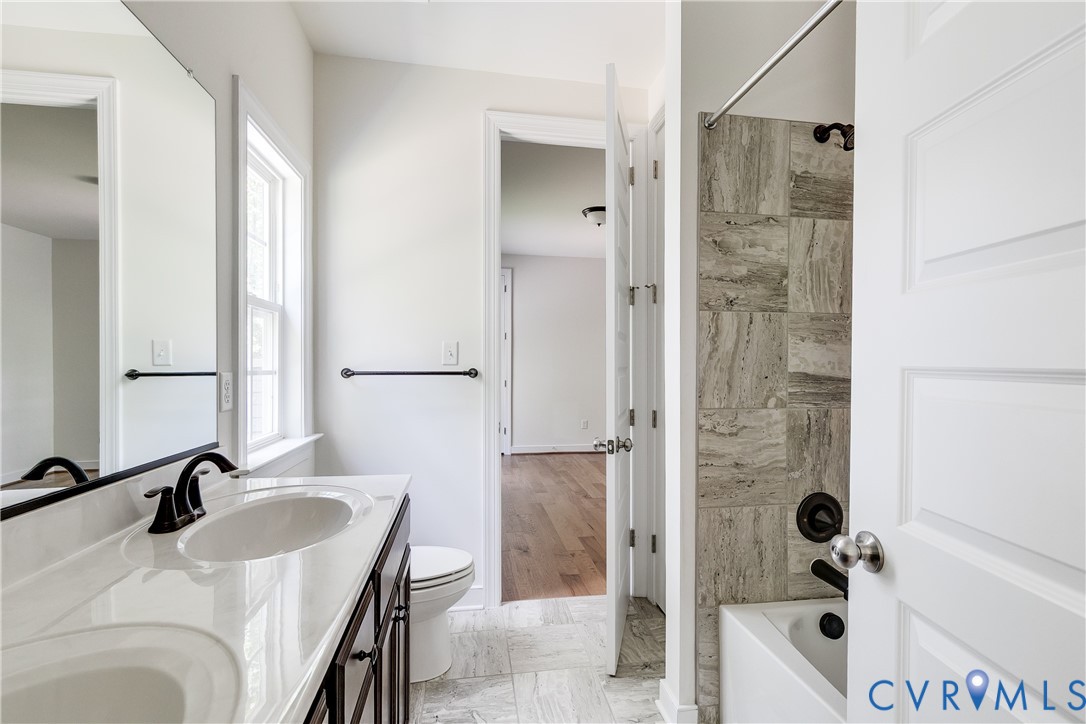 2512 Channelmark Court Chester, VA 23836 - Photo 26 of 36 Bathroom featuring double vanity and washtub / sho