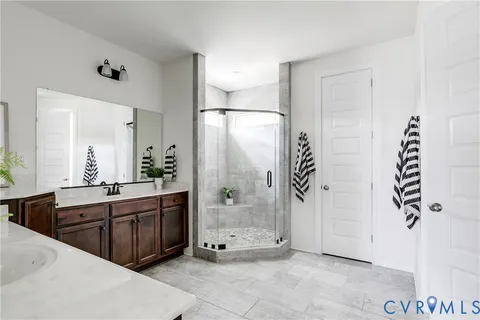 a spacious bathroom with a tub shower and sink