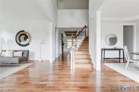 a view of a livingroom with wooden floor and furniture
