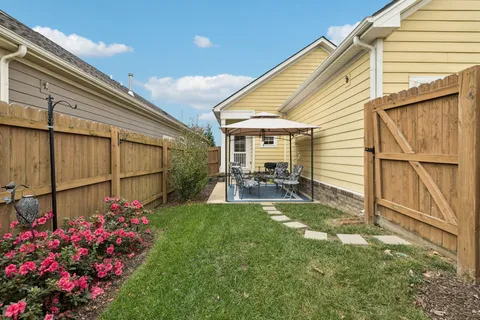 a view of a backyard with garden and flowers