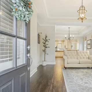 a living room with furniture and a chandelier