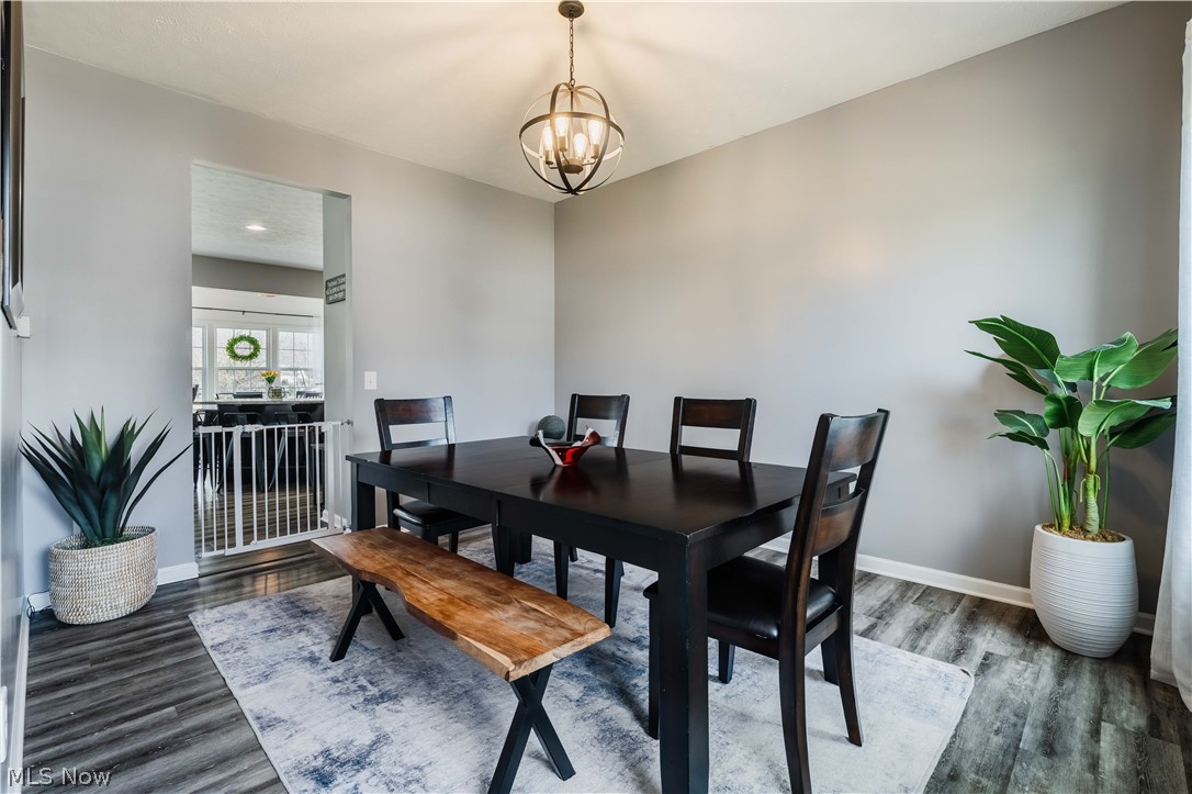6687 List Street Northwest Canton, OH 44708 - Photo 20 of 21 Dining room featuring hanging lights and wood finished floors