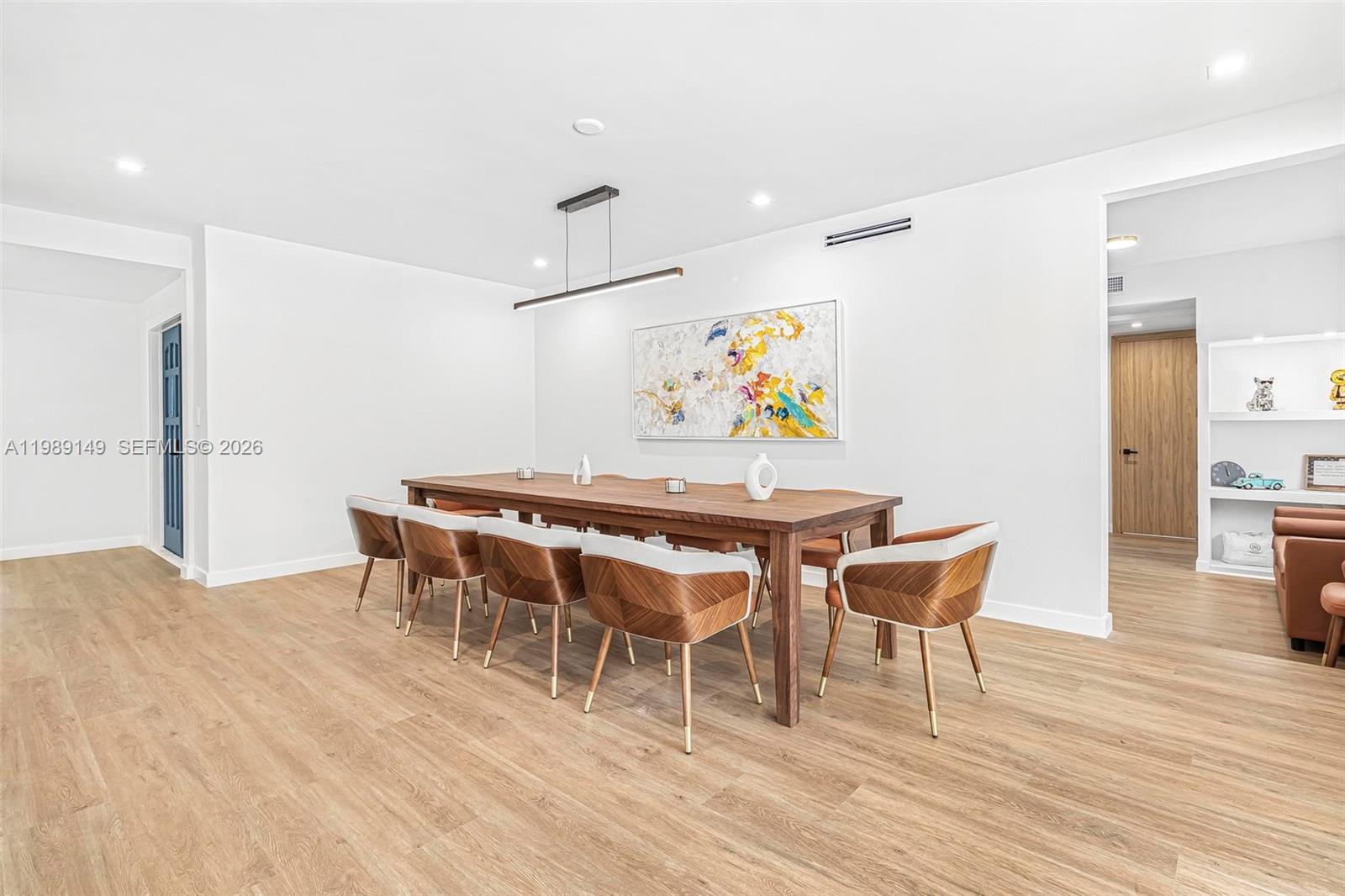 18490 Southwest 83rd Place Cutler Bay, FL 33157 - Photo 15 of 84 a dining room with furniture and a wooden floor