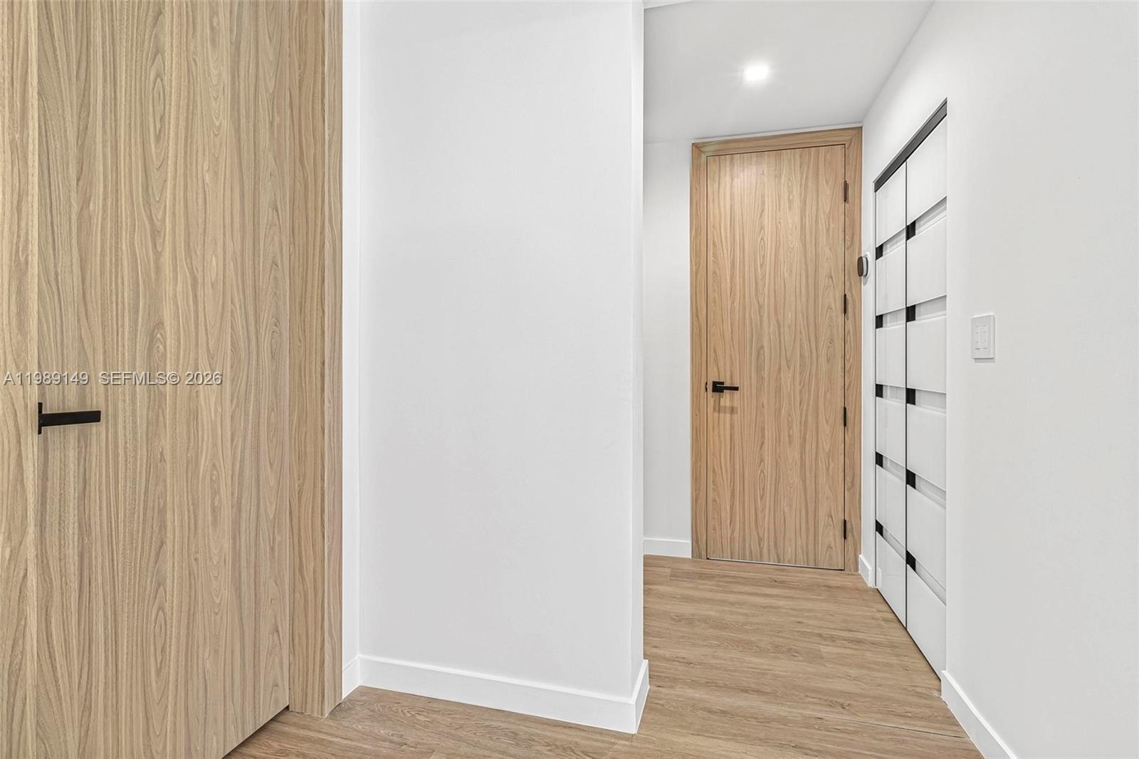 18490 Southwest 83rd Place Cutler Bay, FL 33157 - Photo 23 of 84 a view of a hallway with wooden floor