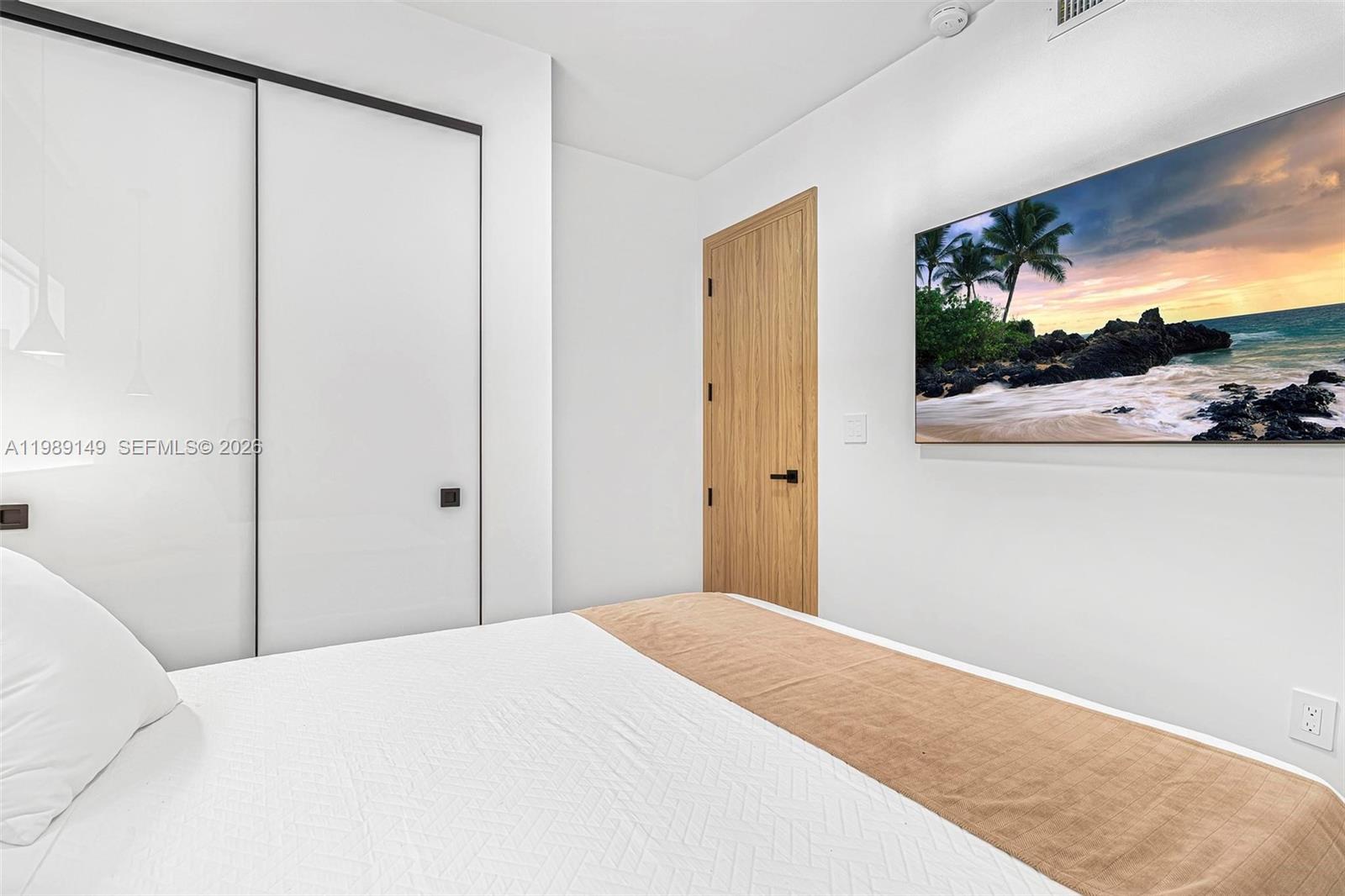 18490 Southwest 83rd Place Cutler Bay, FL 33157 - Photo 26 of 84 a bedroom with a bed and a flat screen tv