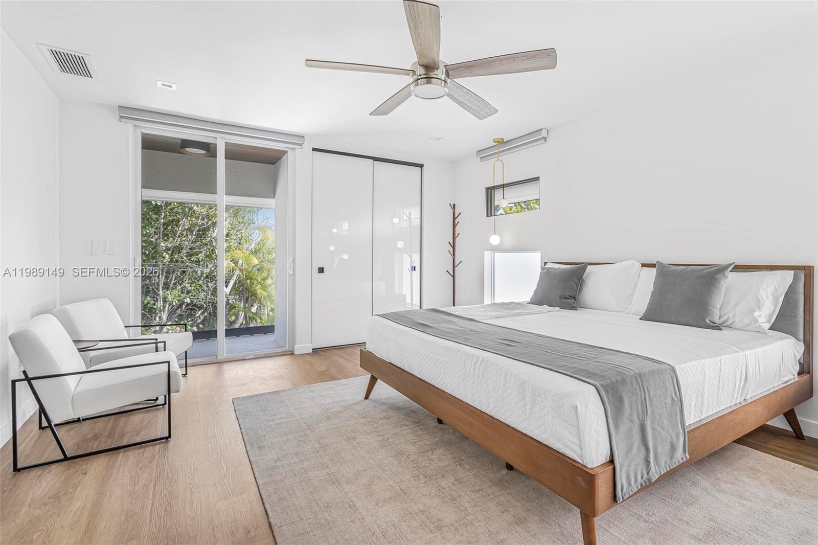 18490 Southwest 83rd Place Cutler Bay, FL 33157 - Photo 35 of 84 a spacious bedroom with a bed and a couch
