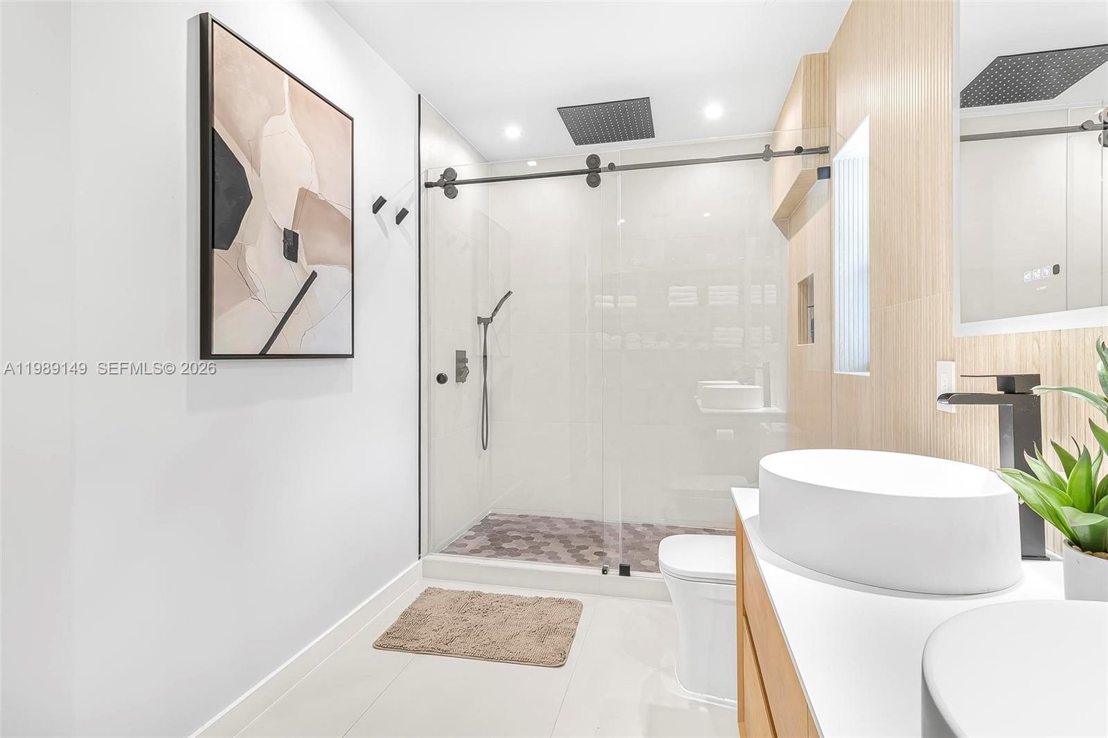 18490 Southwest 83rd Place Cutler Bay, FL 33157 - Photo 45 of 84 a bathroom with a sink a toilet and shower