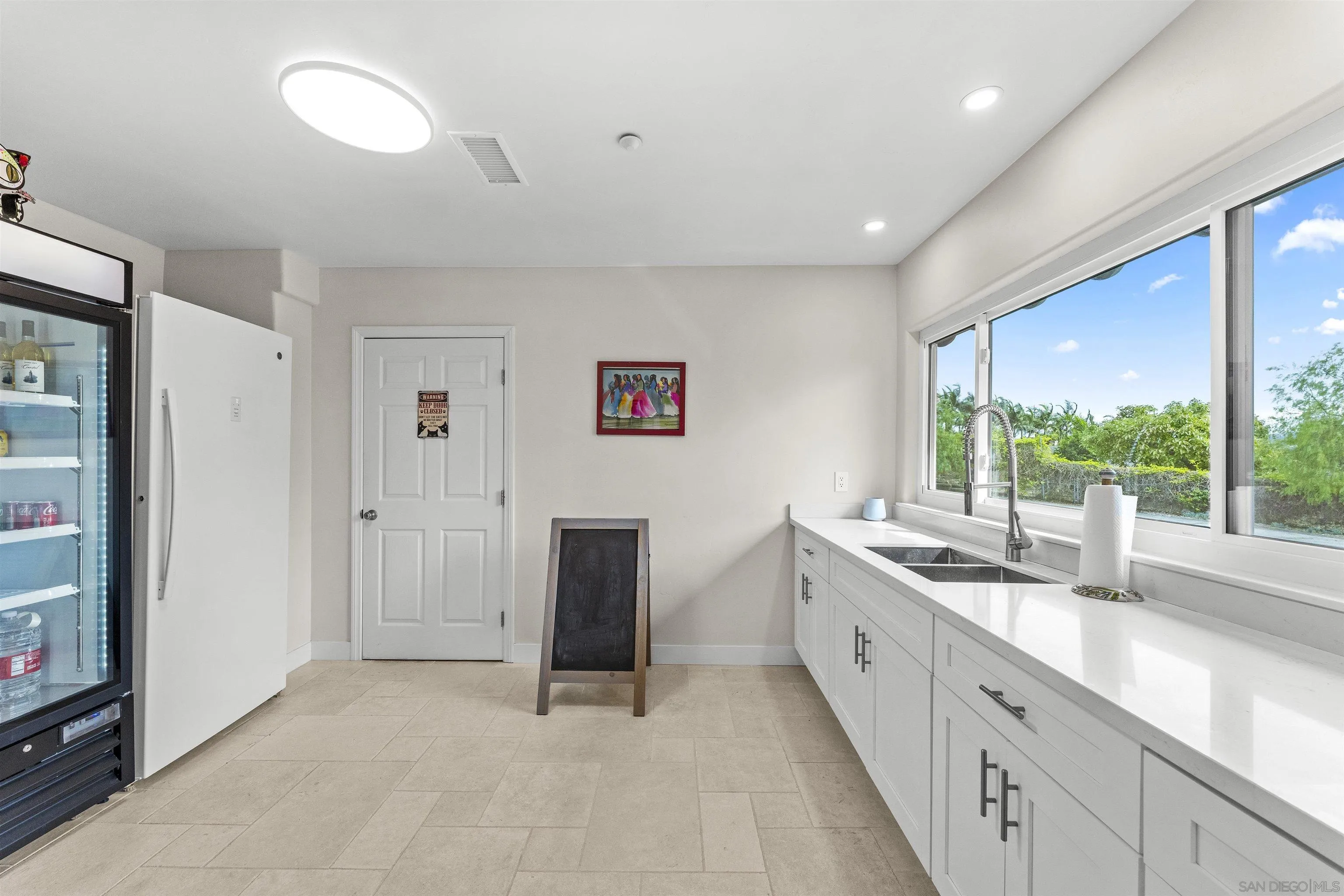 30659 Diaz Road Valley Center, CA 92082 - Photo 31 of 44 a spacious bathroom with a double vanity sink and a large mirror
