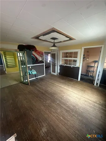 a view of a livingroom with wooden floor and window